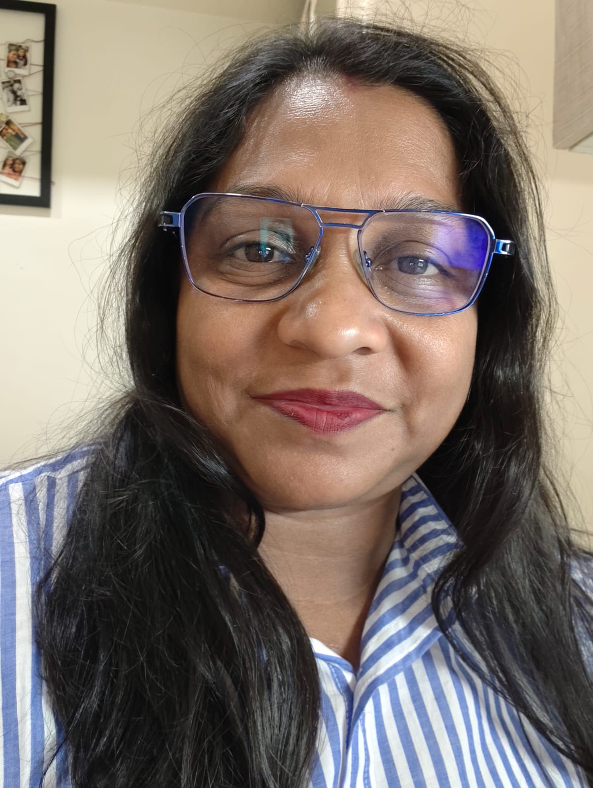 Portrait of Namita Mukherjee smiling in natural light
