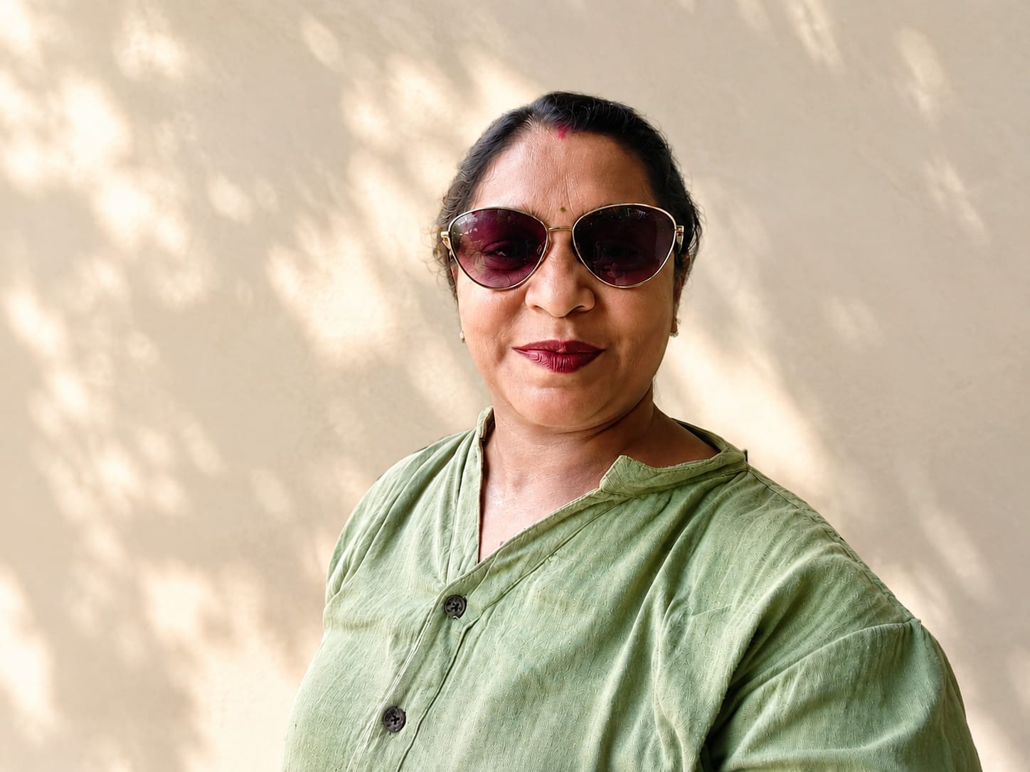Namita Mukherjee in a sage green shirt in warm sunlight